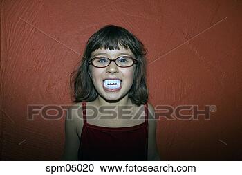 Stock Photography - young girl in 
fake vampire teeth. 
fotosearch - search 
stock photos, 
pictures, images, 
and photo clipart