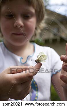 Stock Photography - young girl holding 
butterfly. fotosearch 
- search stock 
photos, pictures, 
images, and photo 
clipart