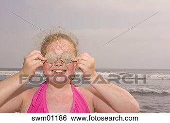 Stock Photo - young girl holding 
seashells over 
her eyes. fotosearch 
- search stock 
photos, pictures, 
images, and photo 
clipart