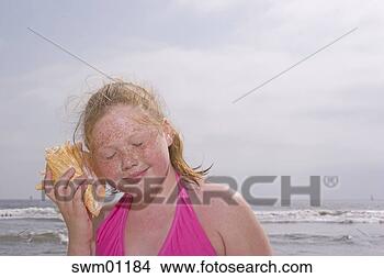 Stock Photo - young girl listening 
to seashell. fotosearch 
- search stock 
photos, pictures, 
images, and photo 
clipart