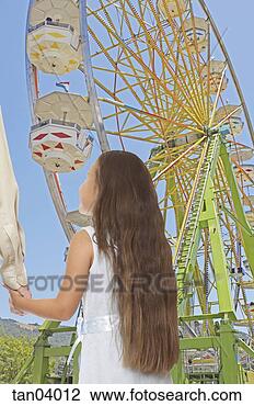Stock Photo - young girl looking 
at ferris wheel. 
fotosearch - search 
stock photos, 
pictures, images, 
and photo clipart