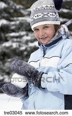 Stock Image - young girl making 
snowball. fotosearch 
- search stock 
photos, pictures, 
images, and photo 
clipart
