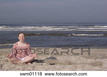 Stock Photo - young girl meditating 
on beach. fotosearch 
- search stock 
photos, pictures, 
images, and photo 
clipart