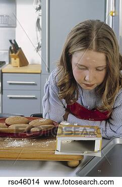 Stock Photo - young girl reading 
cooking instructions. 
fotosearch - search 
stock photos, 
pictures, images, 
and photo clipart