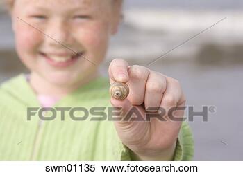 Stock Image - young girl showing 
off shell at the 
beach. fotosearch 
- search stock 
photos, pictures, 
images, and photo 
clipart