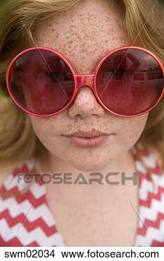 Stock Photo - young girl wearing 
oversized sunglasses. 
fotosearch - search 
stock photos, 
pictures, images, 
and photo clipart