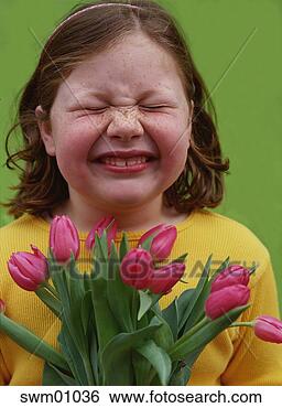Stock Photo - young girl wrinkling 
her nose at tulips. 
fotosearch - search 
stock photos, 
pictures, images, 
and photo clipart