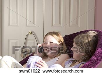Stock Photo - young girls talking 
on telephone. 
fotosearch - search 
stock photos, 
pictures, images, 
and photo clipart