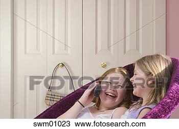 Stock Photo - young girls talking 
on telephone. 
fotosearch - search 
stock photos, 
pictures, images, 
and photo clipart