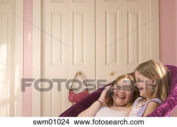 Stock Photo - young girls talking 
on telephone. 
fotosearch - search 
stock photos, 
pictures, images, 
and photo clipart