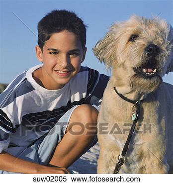 Stock Image - young hispanic 
boy sitting with 
dog. fotosearch 
- search stock 
photos, pictures, 
images, and photo 
clipart