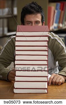 Stock Photo - young man staring 
at large stack 
of books. fotosearch 
- search stock 
photos, pictures, 
images, and photo 
clipart