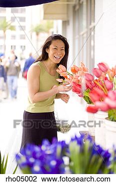Stock Photo - young woman choosing 
flowers at outdoor 
flower market. 
fotosearch - search 
stock photos, 
pictures, images, 
and photo clipart