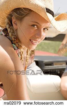 Stock Photograph - young woman in 
cowboy hat smiling. 
fotosearch - search 
stock photos, 
pictures, images, 
and photo clipart