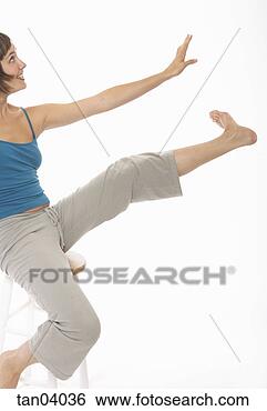 Stock Photo - young woman gesturing 
with arm and leg. 
fotosearch - search 
stock photos, 
pictures, images, 
and photo clipart