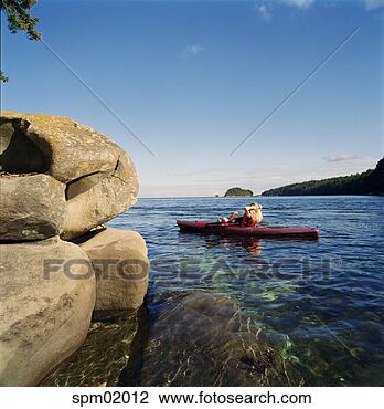 Stock Photo - young woman kayaking 
in lake. fotosearch 
- search stock 
photos, pictures, 
images, and photo 
clipart