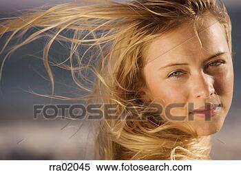Stock Image - young woman’s 
hair blowing in 
the wind. fotosearch 
- search stock 
photos, pictures, 
images, and photo 
clipart