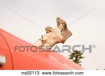 Stock Photo - young woman’s 
feet sticking 
out of car. fotosearch 
- search stock 
photos, pictures, 
images, and photo 
clipart