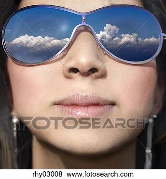 Stock Photo - young woman wearing 
sunglasses with 
cloud reflection. 
fotosearch - search 
stock photos, 
pictures, images, 
and photo clipart
