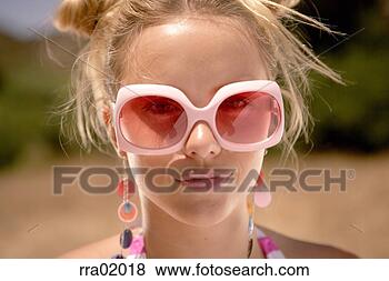 Stock Photo - young woman wearing 
large sunglasses. 
fotosearch - search 
stock photos, 
pictures, images, 
and photo clipart