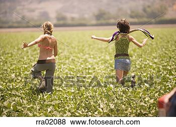 Stock Photo - young women running 
through field. 
fotosearch - search 
stock photos, 
pictures, images, 
and photo clipart