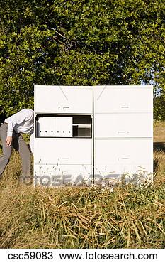 Stock Photo - businessman with 
head behind file 
cabinet. fotosearch 
- search stock 
photos, pictures, 
images, and photo 
clipart
