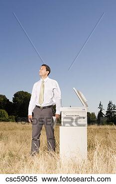 Stock Image - businessman next 
to copier in field. 
fotosearch - search 
stock photos, 
pictures, images, 
and photo clipart