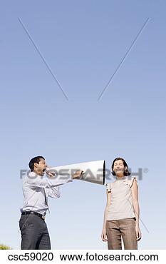 Stock Photography - businessman yelling 
through megaphone 
at businesswoman. 
fotosearch - search 
stock photos, 
pictures, images, 
and photo clipart