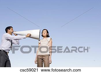 Stock Photography - businessman yelling 
through megaphone 
at businesswoman. 
fotosearch - search 
stock photos, 
pictures, images, 
and photo clipart