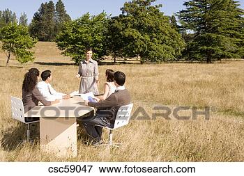 Picture - businesspeople 
at conference 
table in field. 
fotosearch - search 
stock photos, 
pictures, images, 
and photo clipart
