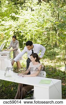 Stock Photo - businesspeople 
looking at computer 
in woods. fotosearch 
- search stock 
photos, pictures, 
images, and photo 
clipart