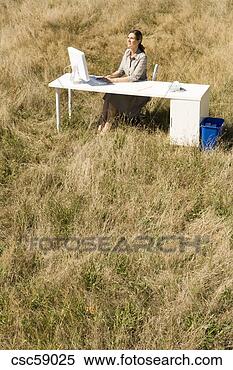 Stock Image - businesswoman 
at desk in field. 
fotosearch - search 
stock photos, 
pictures, images, 
and photo clipart