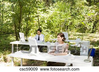 Stock Photograph - businesswoman 
at desk in woods. 
fotosearch - search 
stock photos, 
pictures, images, 
and photo clipart