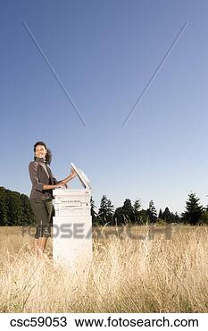 Stock Photo - businesswoman 
next to copier 
in field. fotosearch 
- search stock 
photos, pictures, 
images, and photo 
clipart