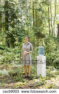 Stock Photo - businesswoman 
next to water 
cooler in woods. 
fotosearch - search 
stock photos, 
pictures, images, 
and photo clipart
