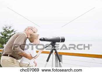 Stock Photograph - grandfather and 
grandson looking 
through telescope. 
fotosearch - search 
stock photos, 
pictures, images, 
and photo clipart