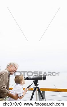 Stock Photography - grandfather and 
grandson looking 
through telescope. 
fotosearch - search 
stock photos, 
pictures, images, 
and photo clipart