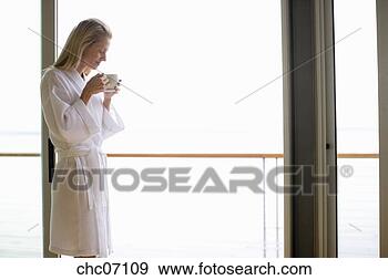 Stock Photograph - woman looking 
out glass door. 
fotosearch - search 
stock photos, 
pictures, images, 
and photo clipart