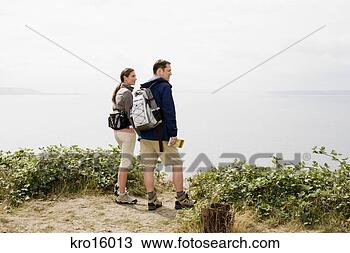 Stock Photo - couple on cliff 
overlooking water. 
fotosearch - search 
stock photos, 
pictures, images, 
and photo clipart