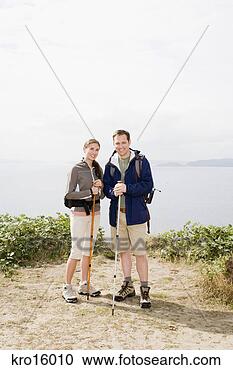 Stock Photography - couple holding 
hiking poles. 
fotosearch - search 
stock photos, 
pictures, images, 
and photo clipart