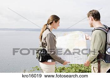 Stock Photograph - couple looking 
at map. fotosearch 
- search stock 
photos, pictures, 
images, and photo 
clipart