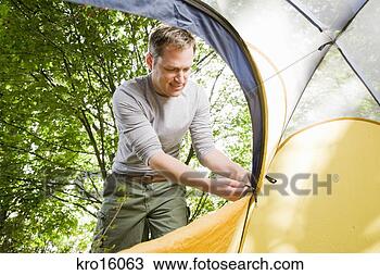 Stock Photo - man zipping up 
tent. fotosearch 
- search stock 
photos, pictures, 
images, and photo 
clipart