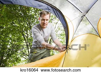 Stock Photo - man zipping up 
tent. fotosearch 
- search stock 
photos, pictures, 
images, and photo 
clipart