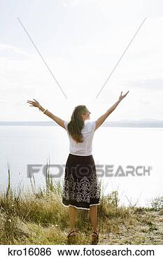 Stock Photo - rear view of woman 
with arms raised. 
fotosearch - search 
stock photos, 
pictures, images, 
and photo clipart