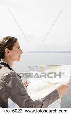 Stock Photo - woman holding 
map. fotosearch 
- search stock 
photos, pictures, 
images, and photo 
clipart