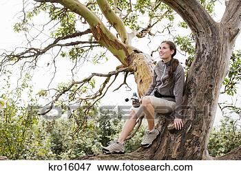 Picture - woman sitting 
in tree. fotosearch 
- search stock 
photos, pictures, 
images, and photo 
clipart