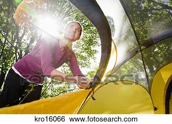 Stock Photo - woman zipping 
up tent. fotosearch 
- search stock 
photos, pictures, 
images, and photo 
clipart