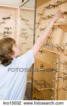 Stock Photo - boy reaching for 
eyeglasses. fotosearch 
- search stock 
photos, pictures, 
images, and photo 
clipart