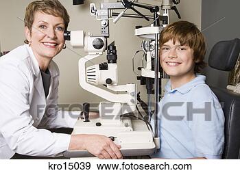 Stock Photograph - female ophthalmologist 
examining boy. 
fotosearch - search 
stock photos, 
pictures, images, 
and photo clipart