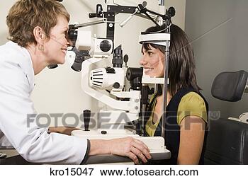 Picture - female ophthalmologist 
examining woman. 
fotosearch - search 
stock photos, 
pictures, images, 
and photo clipart